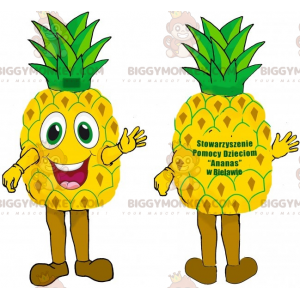 Hyvin hymyilevä jättiläinen keltainen ja vihreä ananas