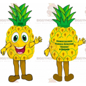Hyvin hymyilevä jättiläinen keltainen ja vihreä ananas