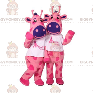 2 BIGGYMONKEY™s Maskottchen aus rosafarbenen und blauen Kühen.